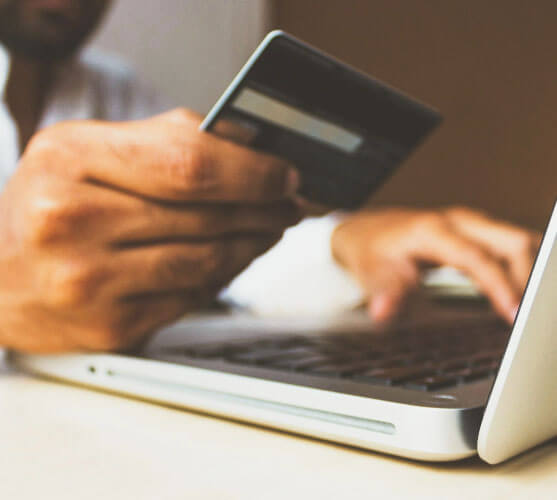 woman using credit card on computer